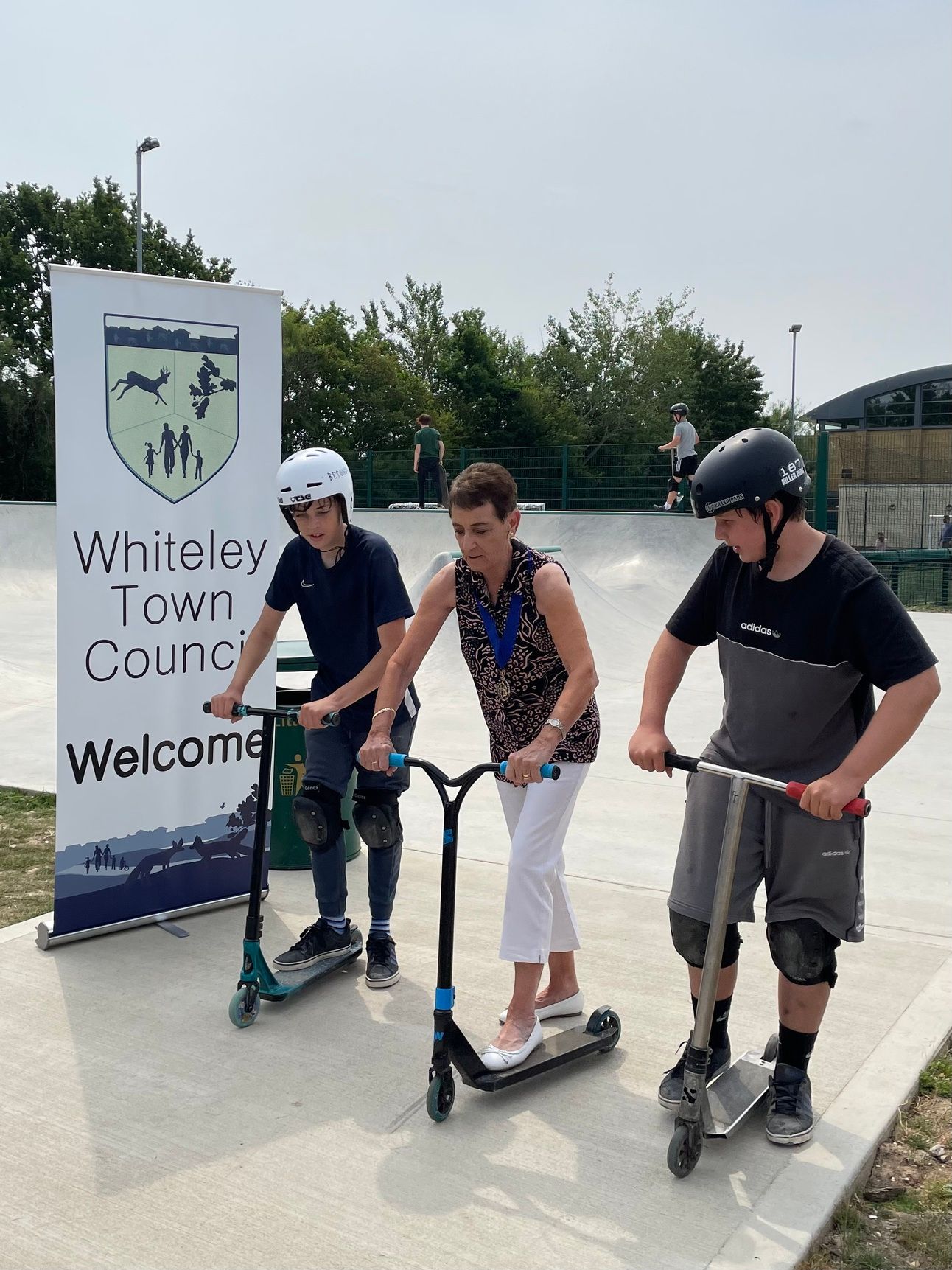 Angela Clear and local teenagers on scooterss