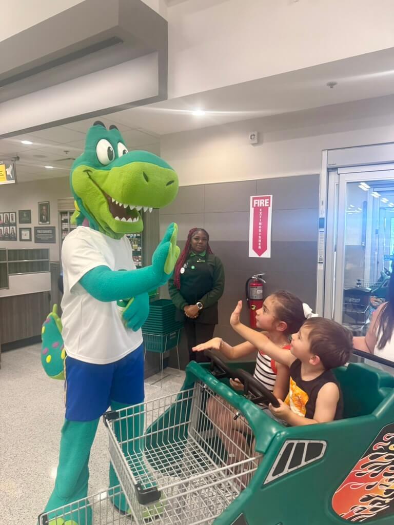 Mascot gives high five to childrenn