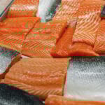 Fresh fish assorted on ice counter in supermarket