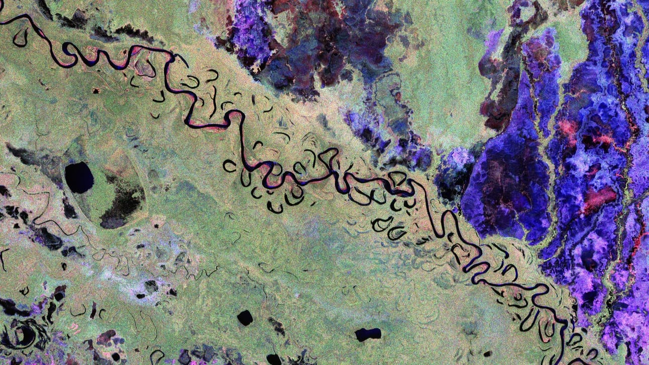 This image from ESA’s Biomass satellite shows a section of Bolivia, a country heavily affected by deforestation, largely due to agricultural expansion. Captured using radar polarisation channels, the image uses color to highlight different landscapes—green for rainforest, red for floodplains and wetlands, blue–purple for grasslands, and black for rivers and lakes. It covers an area roughly 90 km long and 60 km wide, with north positioned to the right. The Biomass mission will help track changes in forest carbon over time.