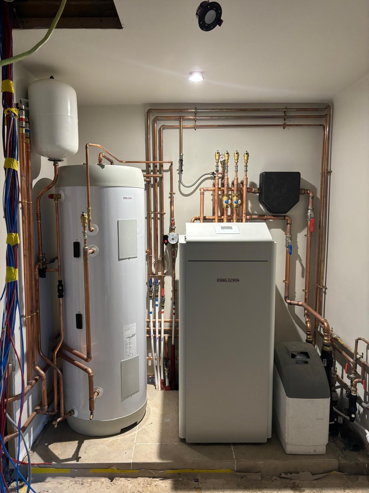 Stiebel Eltron WPE 15kW ground source heat pump installation in a professional plant room with copper pipework.