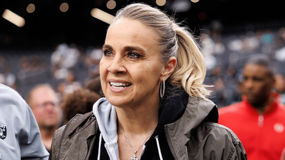 Head coach Becky Hammon of the Las Vegas Aces stands on the sidelines prior to an NFL football game