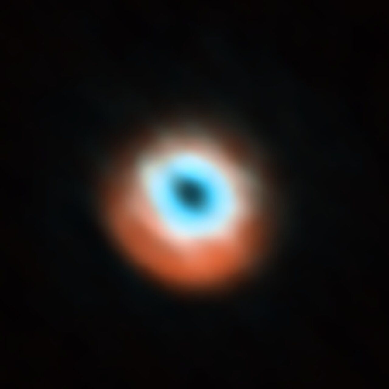 This image, taken with the Atacama Large Millimeter/submillimeter Array (ALMA), and first released in 2015, shows a planet-forming disc around the young star HD 135344B. The image combines a view of both the gas (blue) and the dust (orange) around the star. The star itself is invisible at these wavelengths, and is located in the central gap of the disc. (Credit: ALMA (ESO/NAOJ/NRAO)/N. van der Marel et al.)