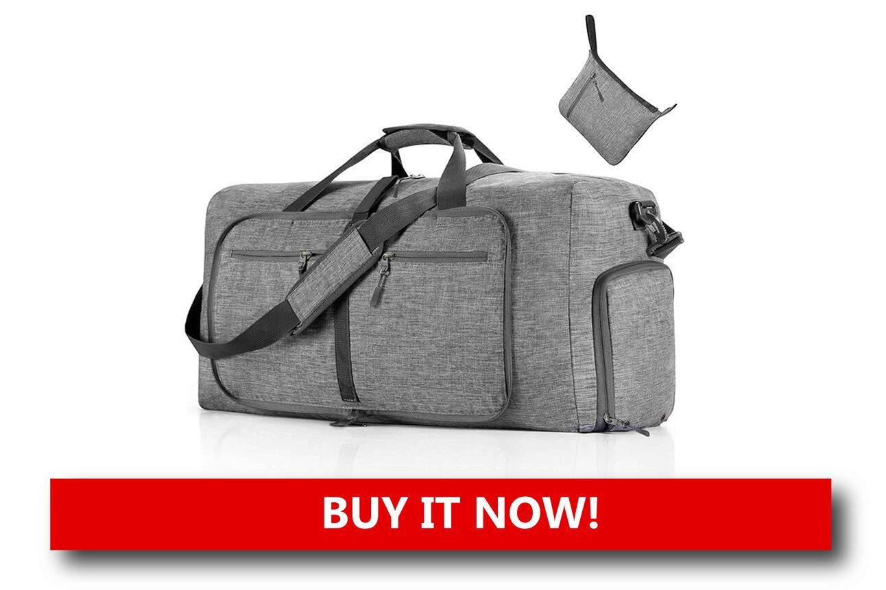 A Foldable Duffel for Souvenir Overflow A foldable duffel bag partially packed with vacation souvenirs, sitting atop a wheeled suitcase in a hotel room ready for departure.