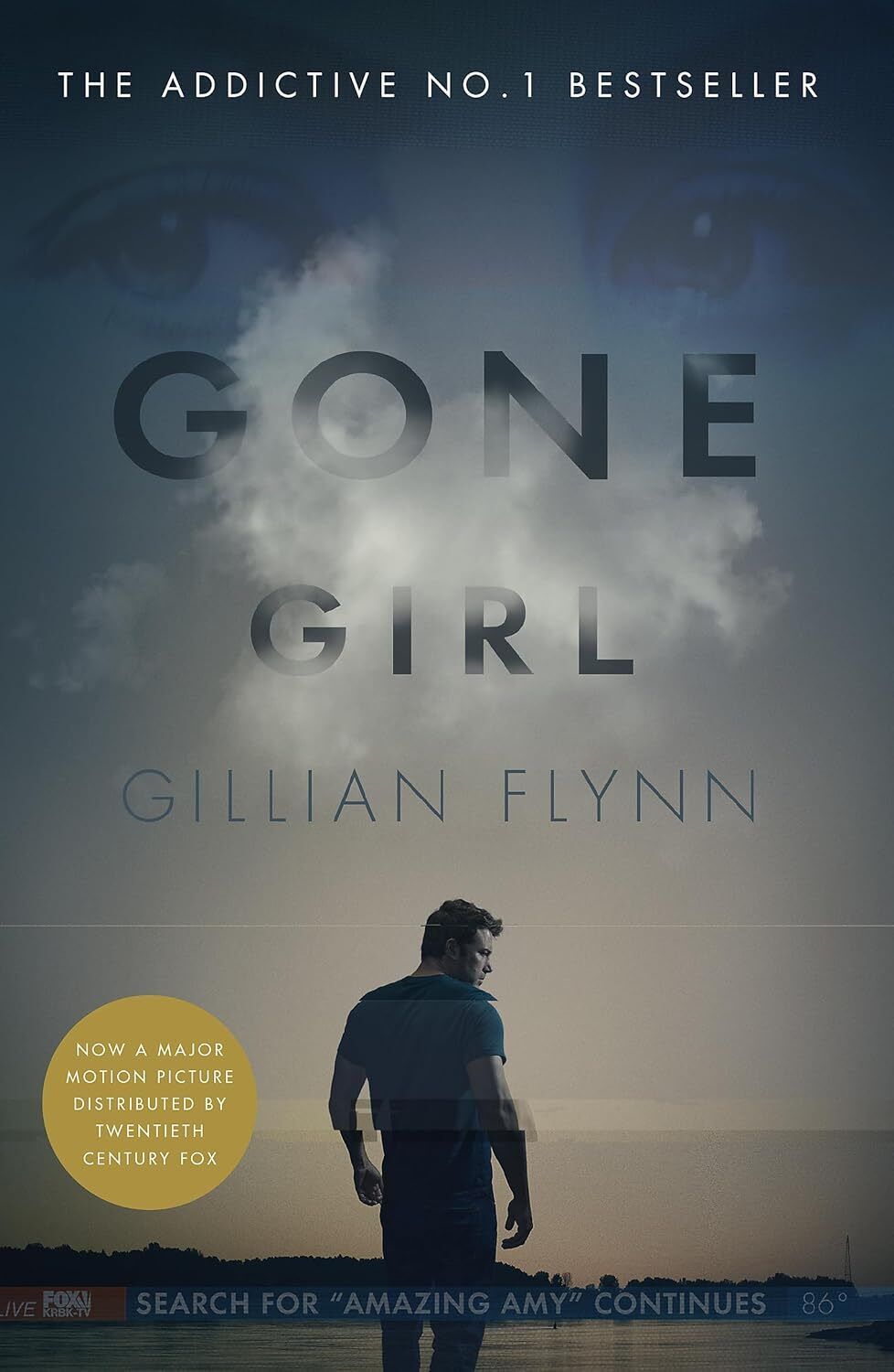 Cover of Gone Girl by Gillian Flynn, featuring a shadowy figure against a stormy sky, evoking mystery and deception.