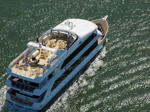 A large white boat floating on top of water.