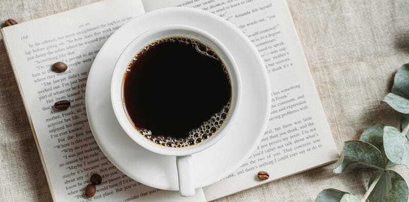 Cup of coffee resting on an open book, symbolizing calm focus and mindful routines.
