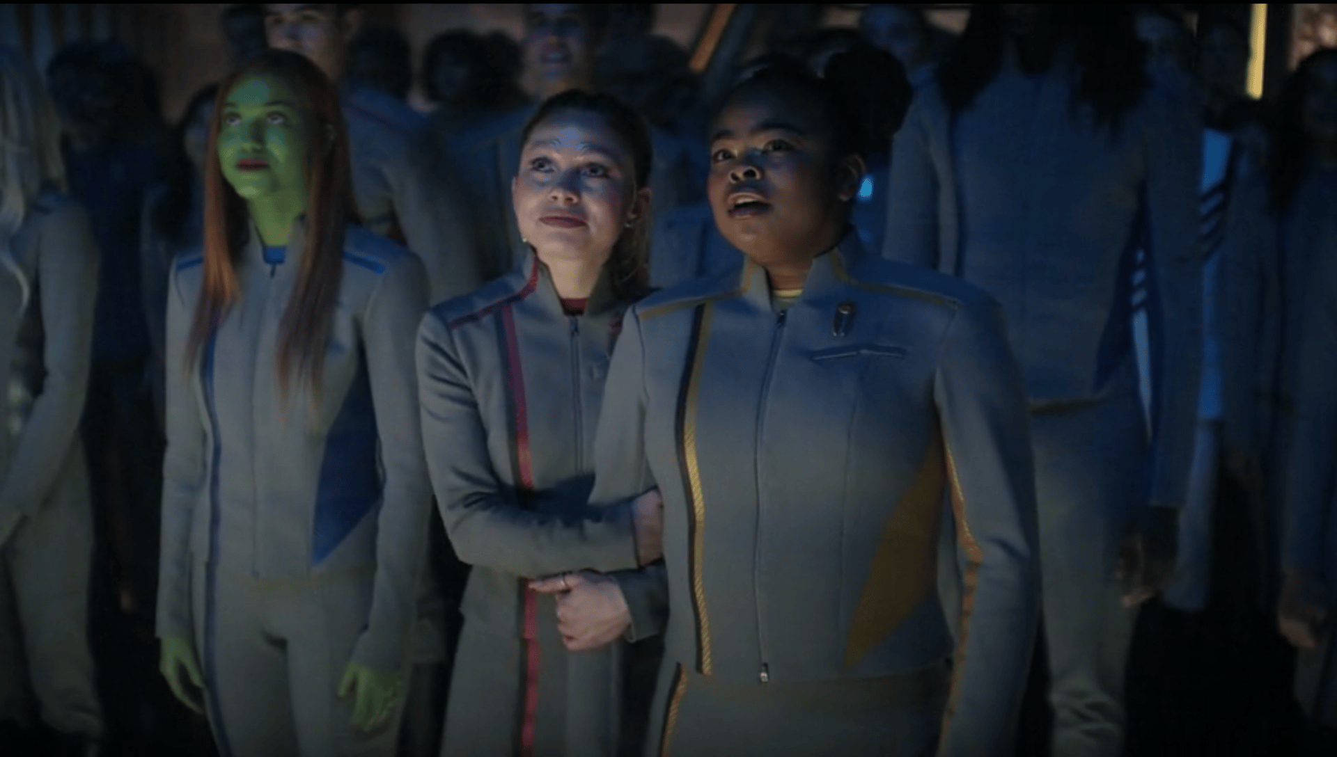 Genesis holding on to Sam's arm as they look out the window