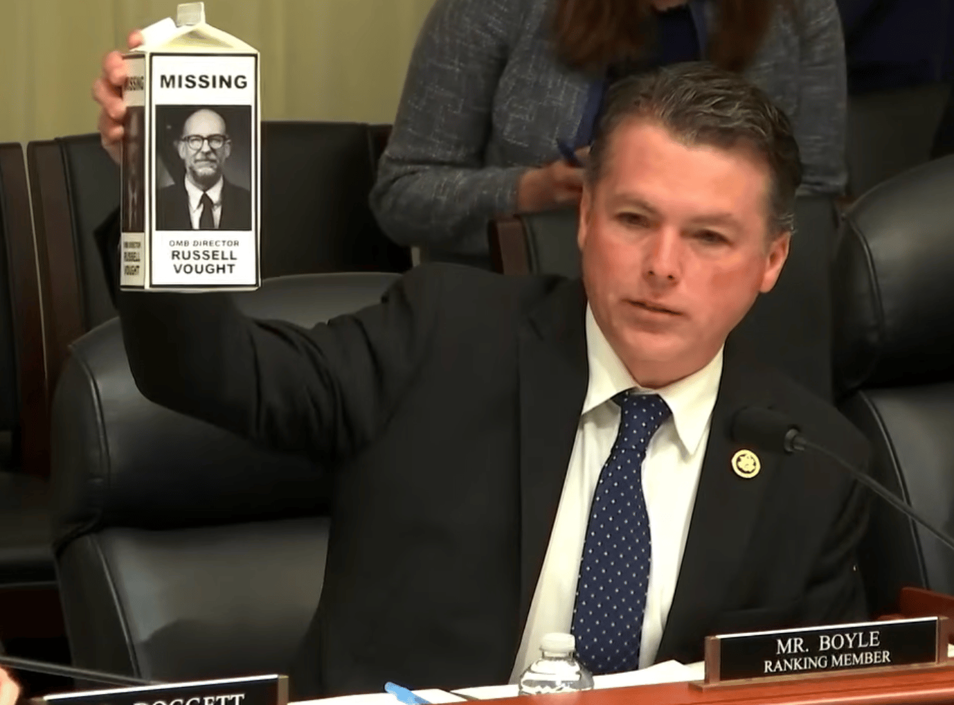 House Budget ranking member Brendan Boyle (D-Pa.) holds up a milk carton with "MISSING: Russell Vought"