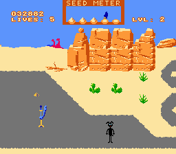 A screenshot from the NES port of Road Runner, showing Wile E. Coyote having just suffered an explosion of some kind. He's now covered in black soot and ash, staring out at the player and camera, humiliated just like Chuck Jones would have wanted.