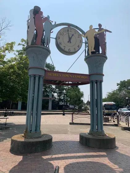 A decorative clock over Dudley Town Common with text that says "Dudley Town Common"