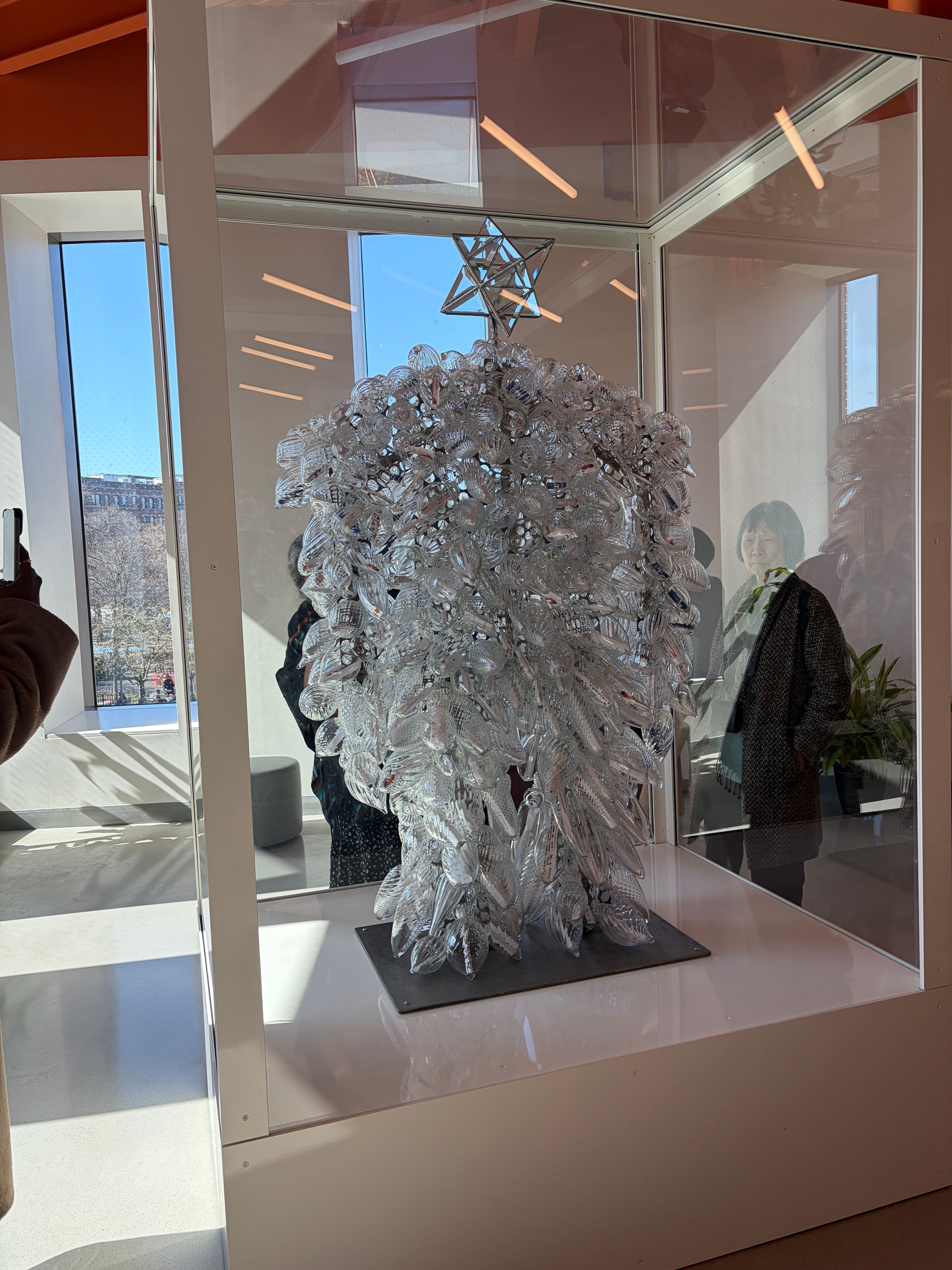 Sculpture made out of handblown glass vessels in a steel and glass vitrine
