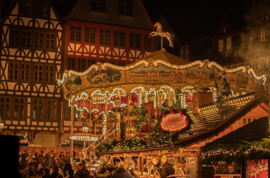a beautiful historic carousel at the Frankfurt Christmas Market in Germany. The amazing medieval truss houses create an unfathomable beautiful “winter wonderland” atmosphere.