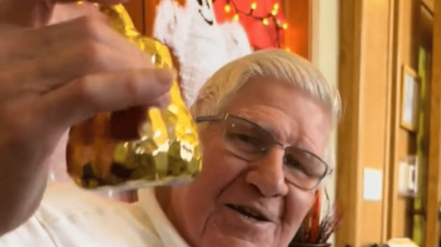 Image shows a proud Grandpa Jerry after winning the nursing home door decorating contest.
