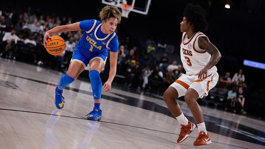 Kiki Rice #1 of the UCLA Bruins drives to the basket during the second half against the Texas Longhorns during the Players Era Championship basketball tournament.