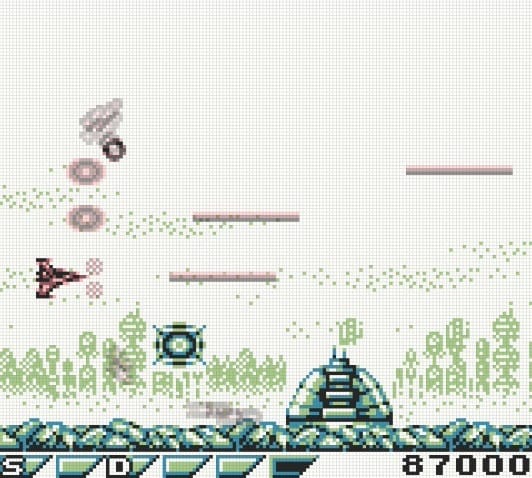 A screenshot showing the Vic Viper taking the fight to the enemy city, which is featured in the game's background while aerial defenses assault it.