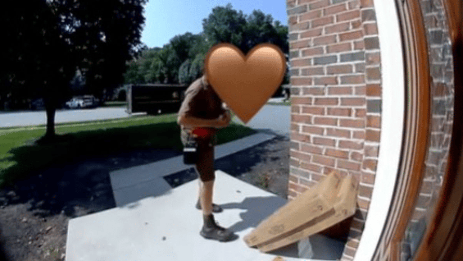 Image shows a delivery driver that returned to a porch to add something to the package.