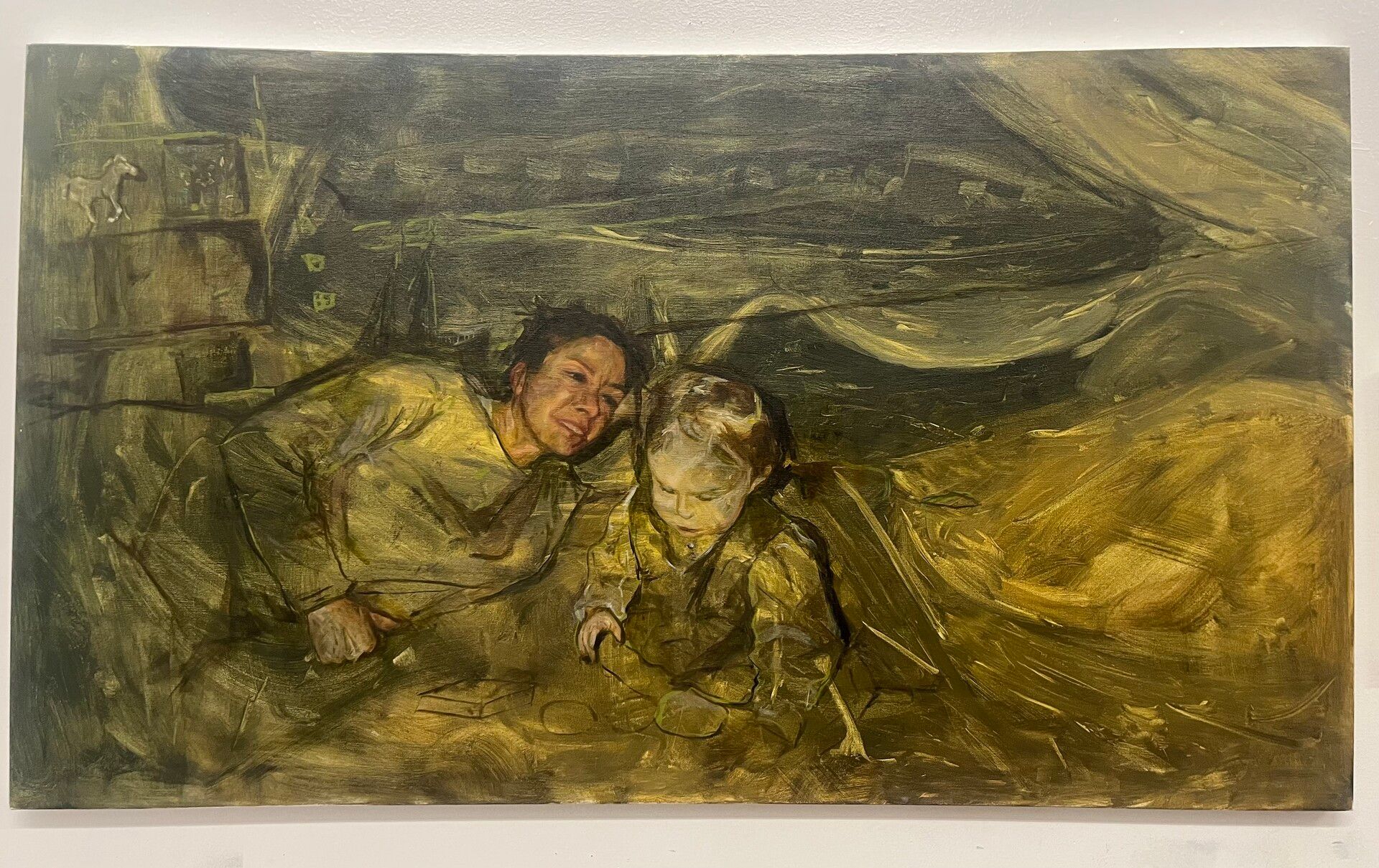 Painting by India Sax of an adult and a child lying together on the floor, dark yellow and green tones. Arts newsletter.