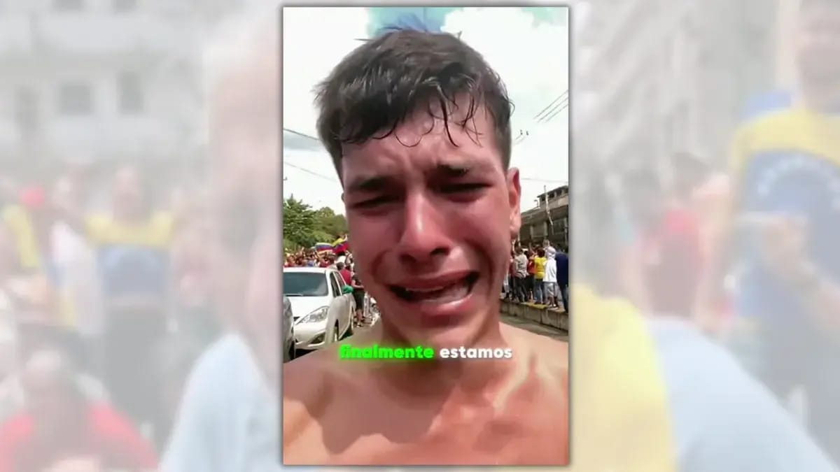 Close up of what appears to be a shirtless man crying with a crowd behind him