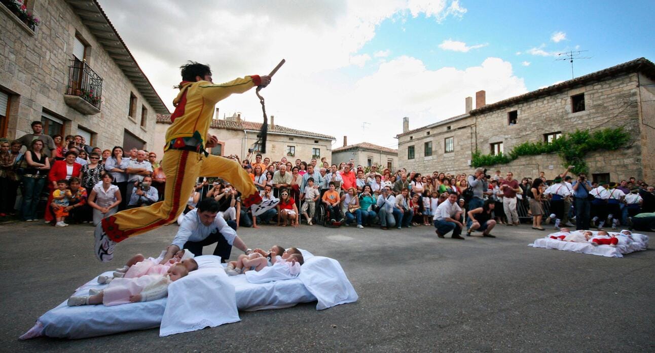 A man, representing the devil, jumping over babies in an annual festival called El Colacho, in celebration of the feast of Corpus Christi