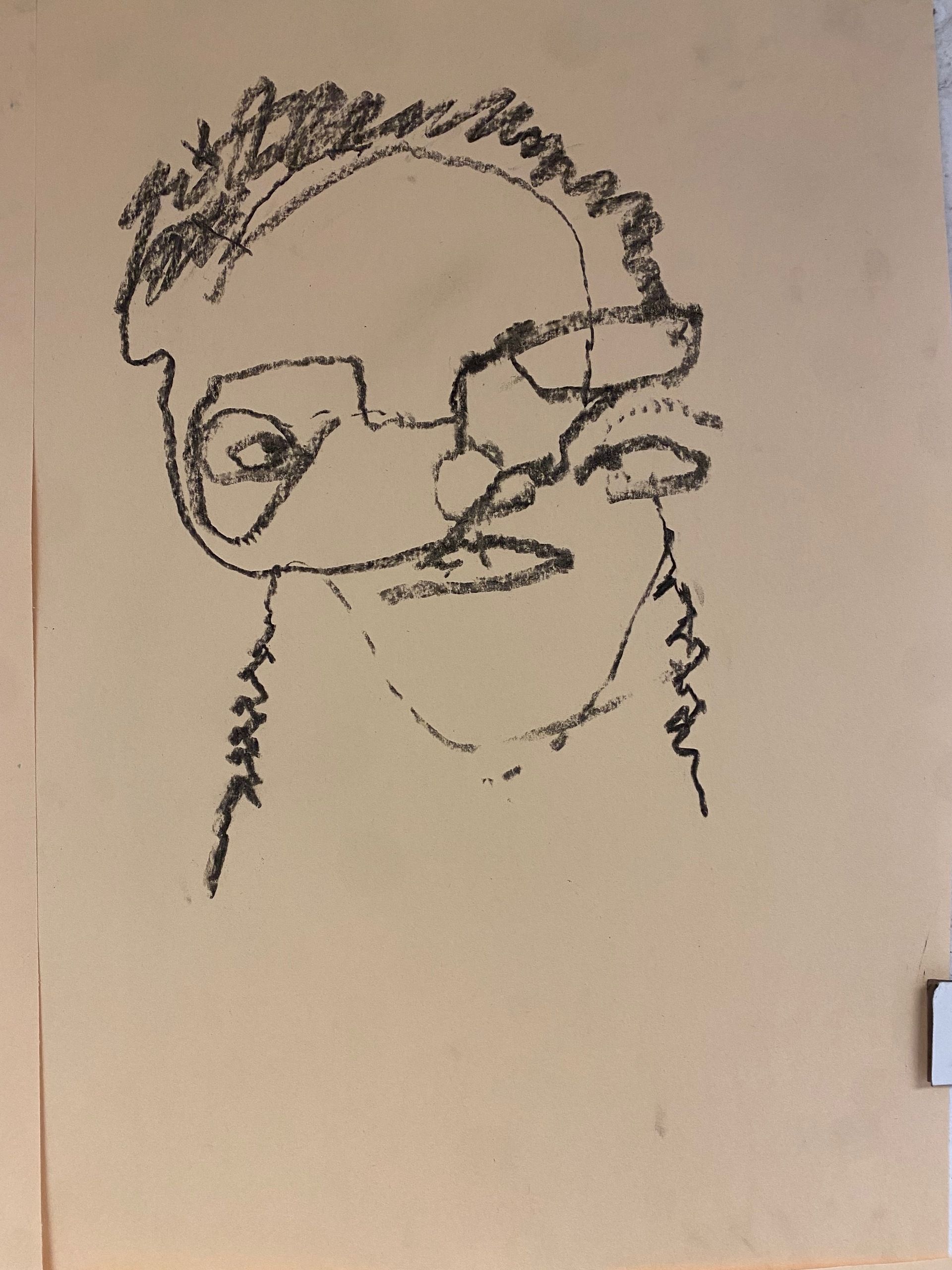 Charcoal sketch of my face; my eyes are misaligned, and everything is a bit crooked and slanted.