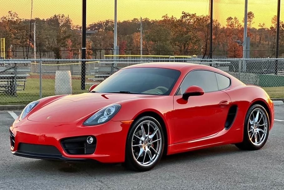 Carmine Red 2015 Porsche 981 Cayman with chrome wheels, low miles, and PDK transmission, priced at $28,500 in Little Rock, Arkansas. Clean condition, rare color.