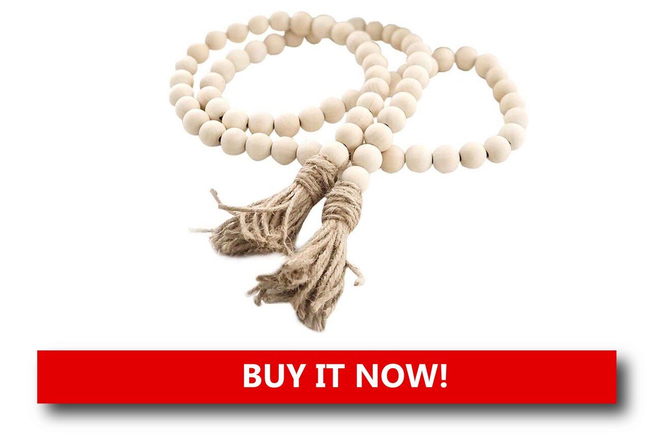Wooden Bead Prayer Beads Alt text: Earth-toned wooden prayer beads featuring a small dove pendant and green ribbon accent, placed among pine branches and holiday lights.