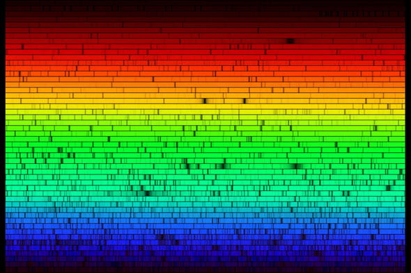 A rainbow colored series of horizontal lines with gaps in them, representing the color of light the sun emits and the elements in it absorbing specific wavelengths.