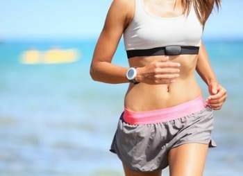 Woman running with a cardio GPS running watch