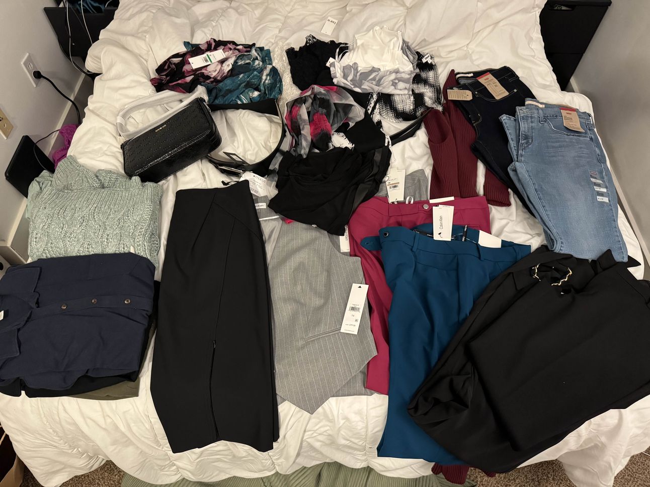 photo of all of the clothes bought laid out on a bed.