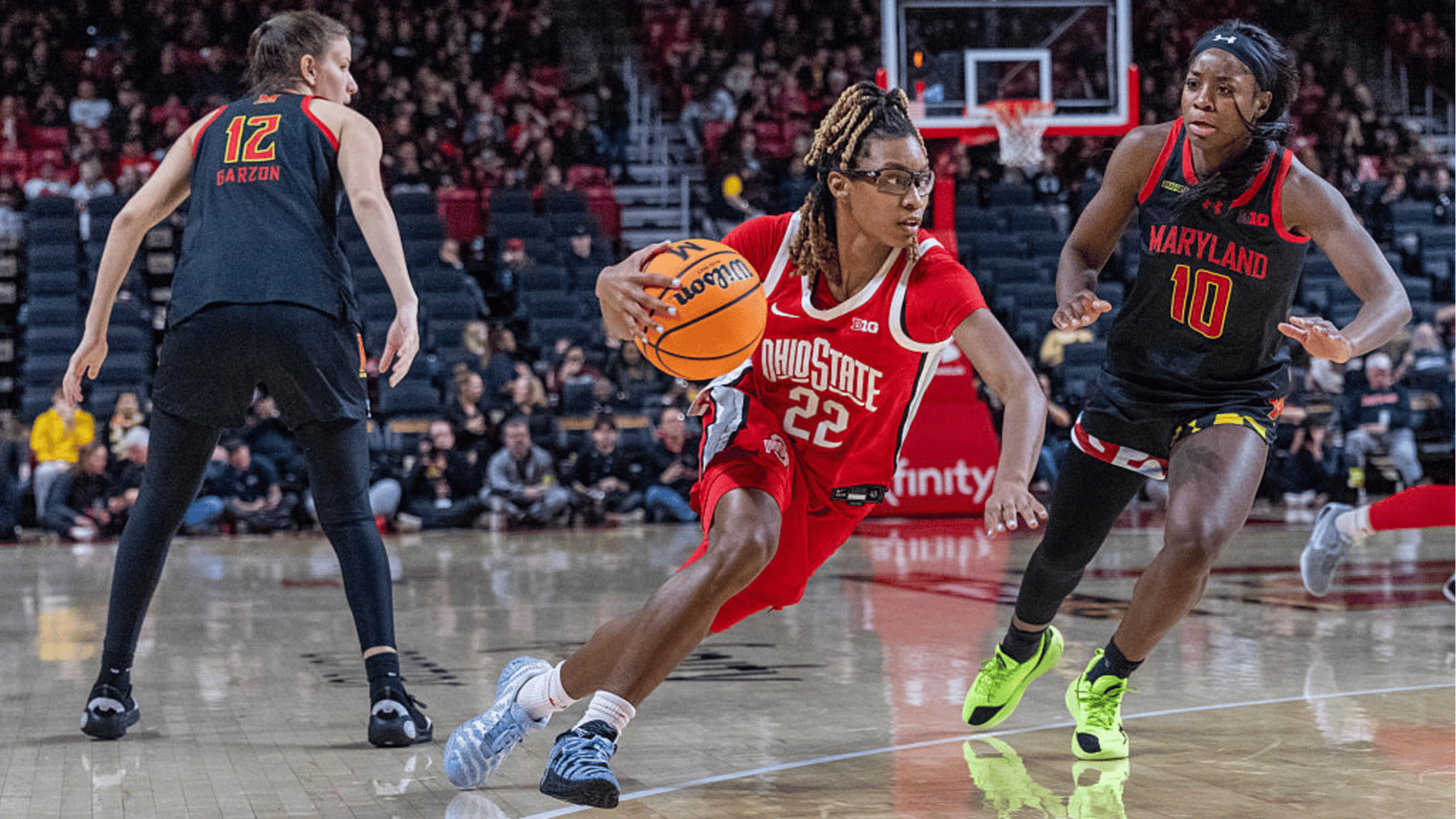 Ohio State Buckeyes guard Jaloni Cambridge (22) bursts between Maryland Terrapins guard Yarden Garzon (12) and guard Mir McLean (10) during a women's college basketball game between the Maryland Terrapins and the Ohio State Buckeyes on January 11, 2026, at Xfinity Center, in College Park, Maryland.