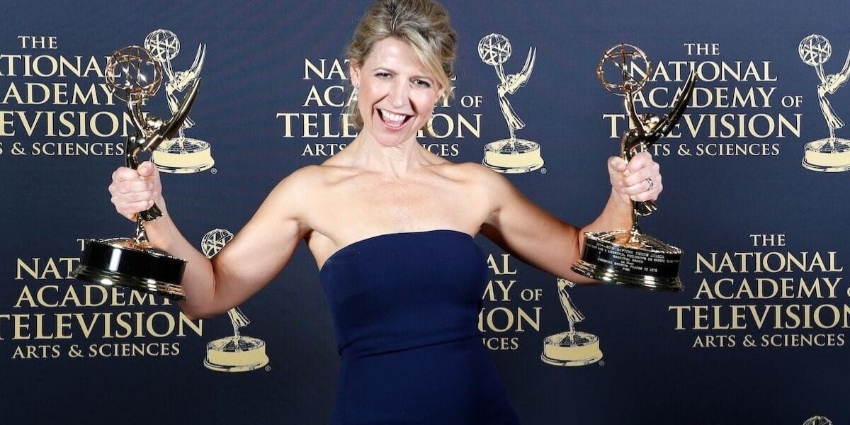 Samantha Brown holding up Emmys