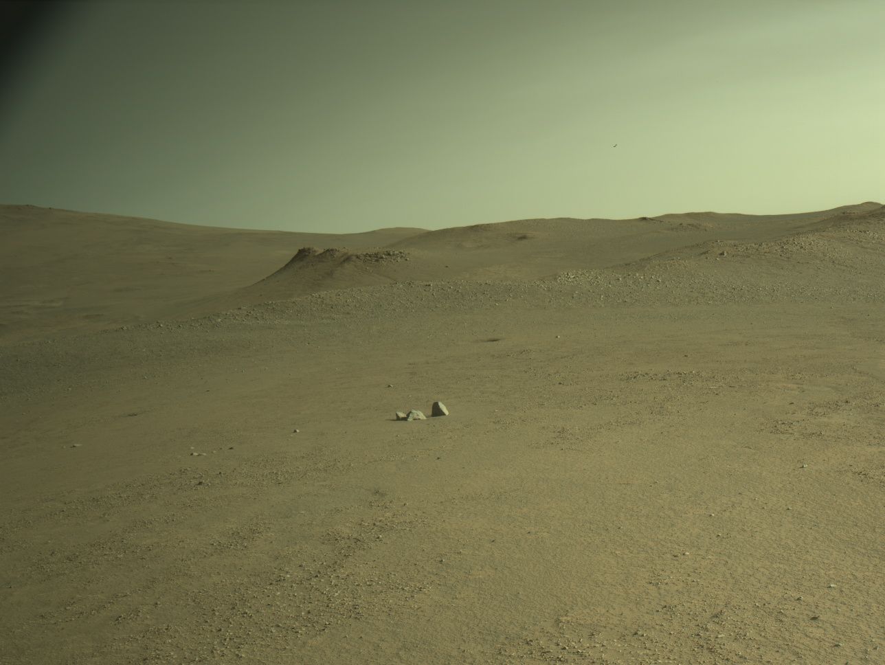 Martian terrain viewed by NASA’s Perseverance rover from atop Soroya Ridge, a light-toned outcrop rising above the surrounding landscape near Jezero Crater. Captured on Sol 1597 using the Left Navigation Camera, the image shows exposed bedrock selected for detailed analysis of surface textures and chemical composition. Soroya was identified from orbit as a promising science target due to its elevated structure and distinct coloration.