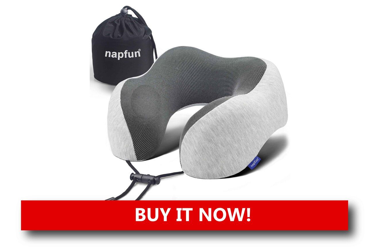 A Travel Pillow That Actually Supports Your Neck A gray memory foam travel pillow with ergonomic U-shaped design, resting on an airplane seat with a cozy travel blanket nearby.