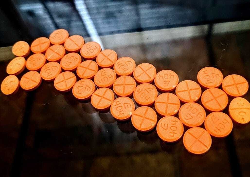 orange round medication pill lot
