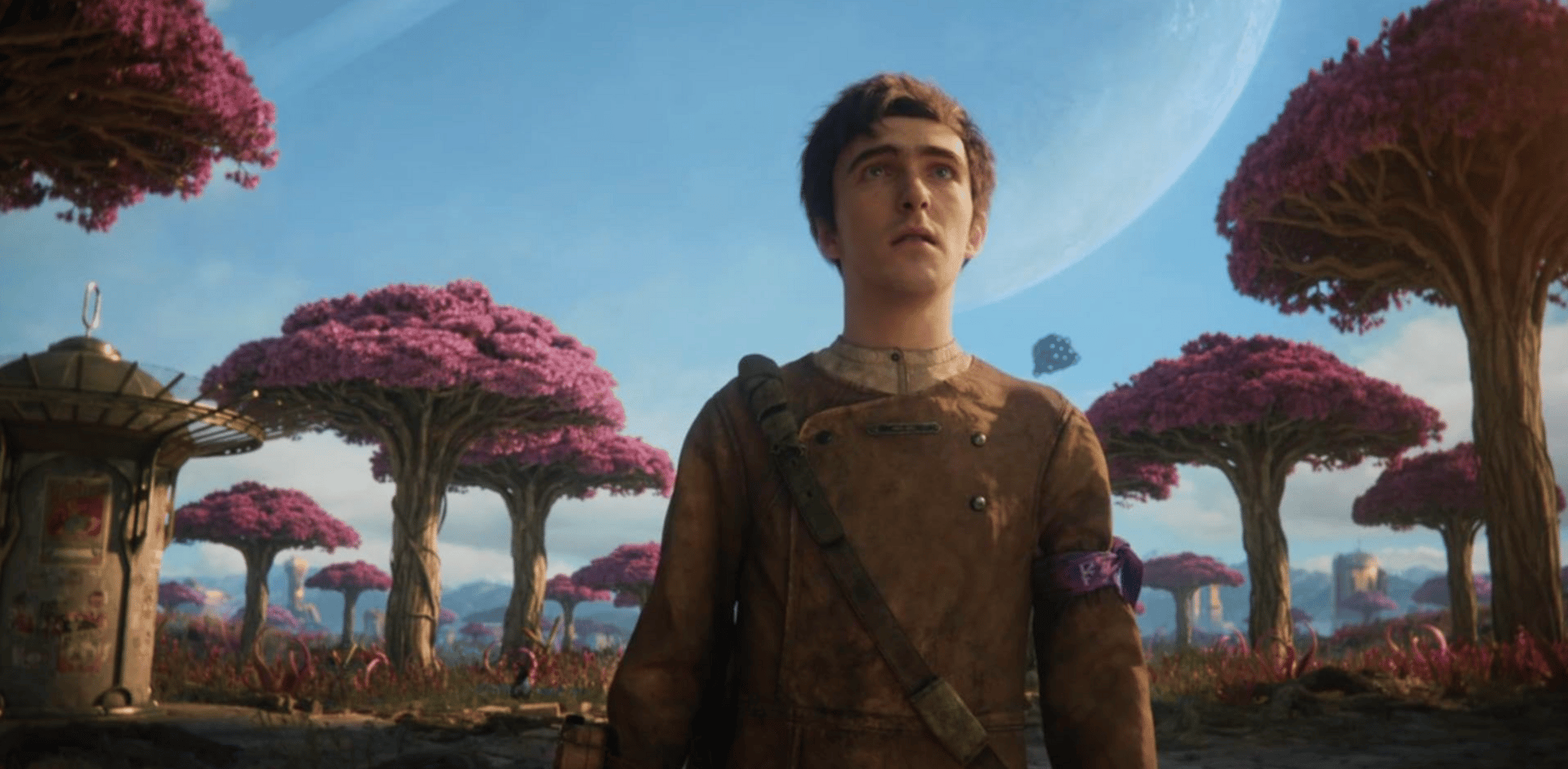 Still from a computer animated scene, showing a doe-eyed young man looking into the distance with purple, alien looking trees in the background.
