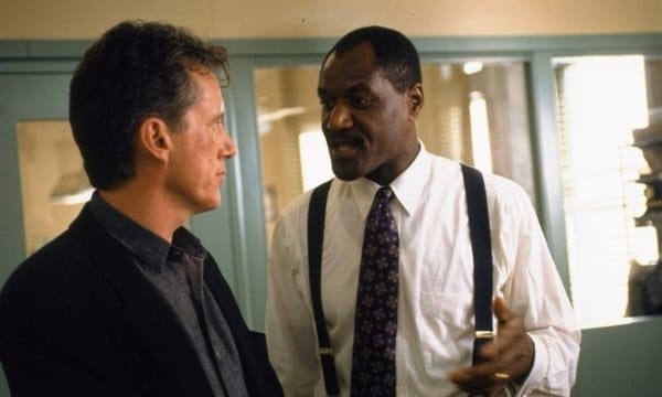 Delroy Lindo as a stern detective in a scene from The Hard Way, a 1991 action-comedy, standing alongside Michael J. Fox.