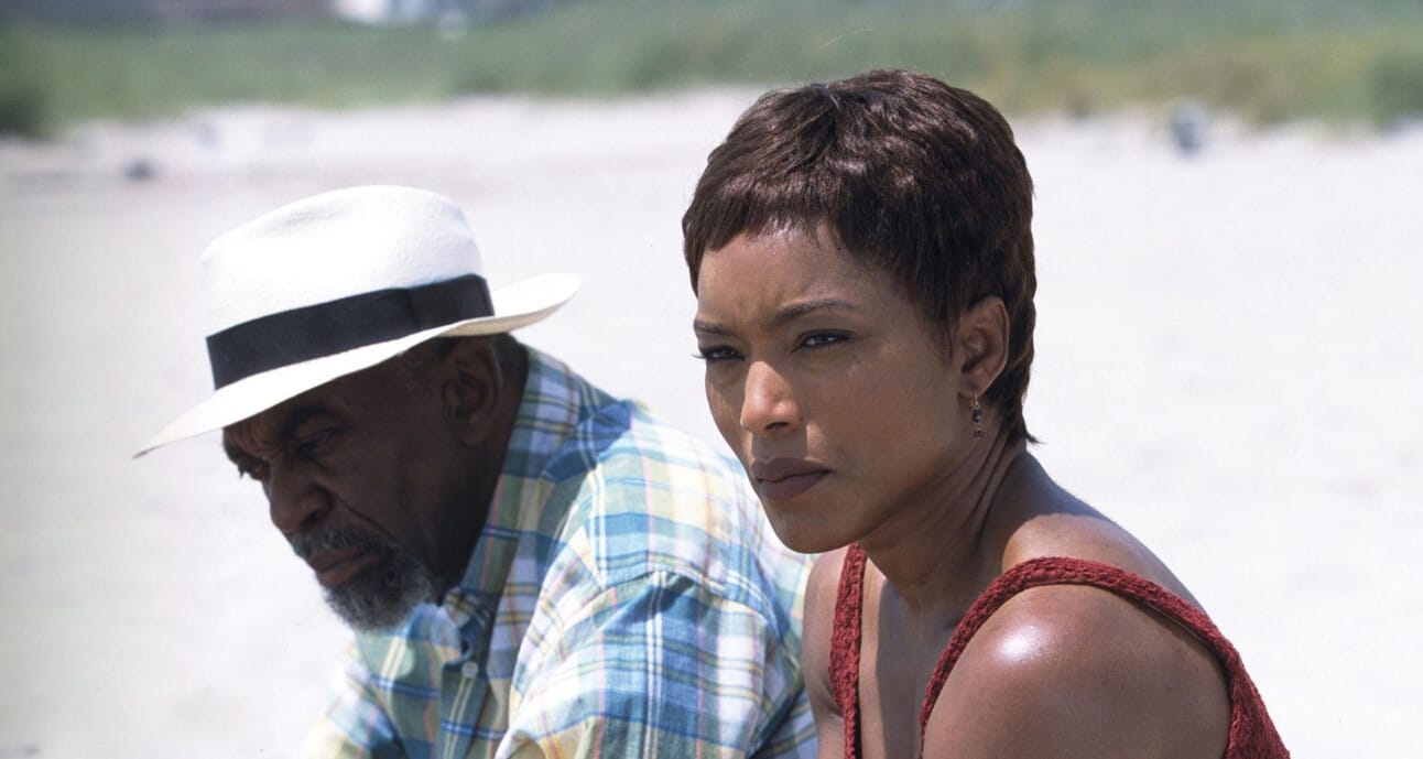 Screenshot of Angela Bassett as Desiree in Sunshine State, walking through her hometown in casual clothes with a reflective expression.