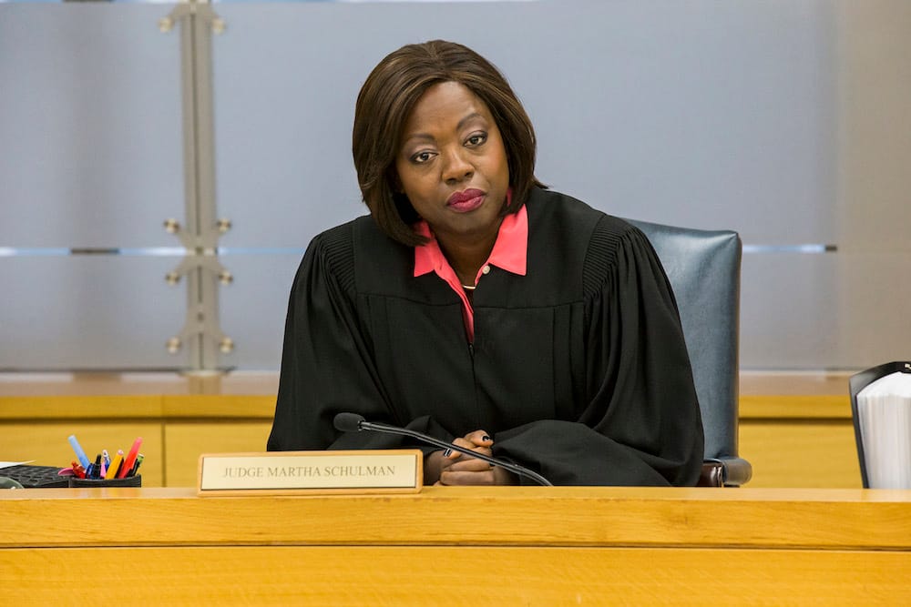  Viola Davis wearing judge's robes, looking thoughtful and authoritative in a courtroom setting as Judge Martha Schulman in 'Custody'.