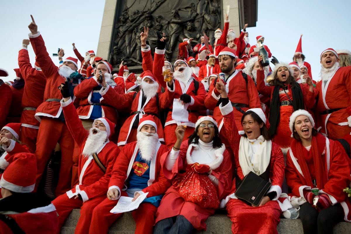 A group of people wearing red and white outfits appear to sing in a group.