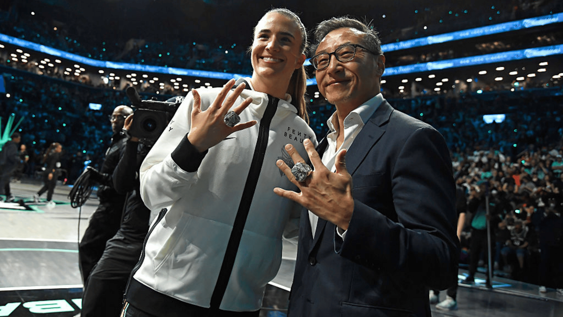 Sabrina Ionescu #20 poses with the New York Liberty owner Joe Tsai during the New York Liberty 2025 championship ring ceremony before the game against the Las Vegas Aces during a WNBA game on May 17, 2024 at Barclays Center Arena in Brooklyn, New York.