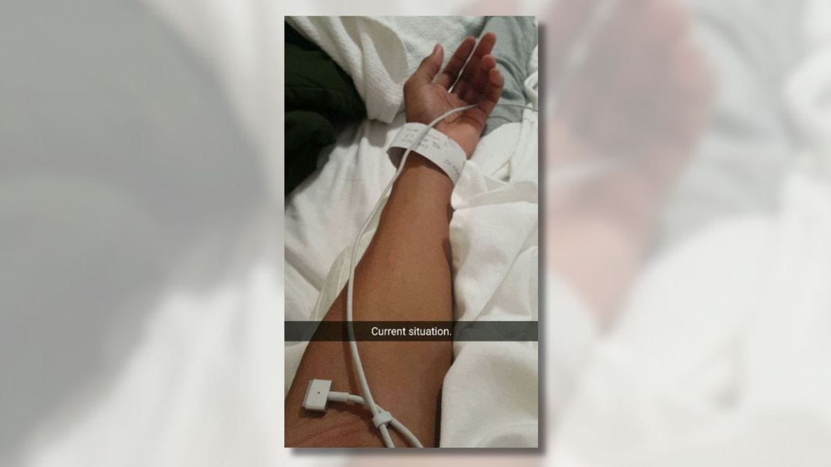 An alleged photo showed a person's arm wearing what appeared to be a hospital bracelet with an Apple MacBook charger wire draped across it. The image is titled, "Current situation."