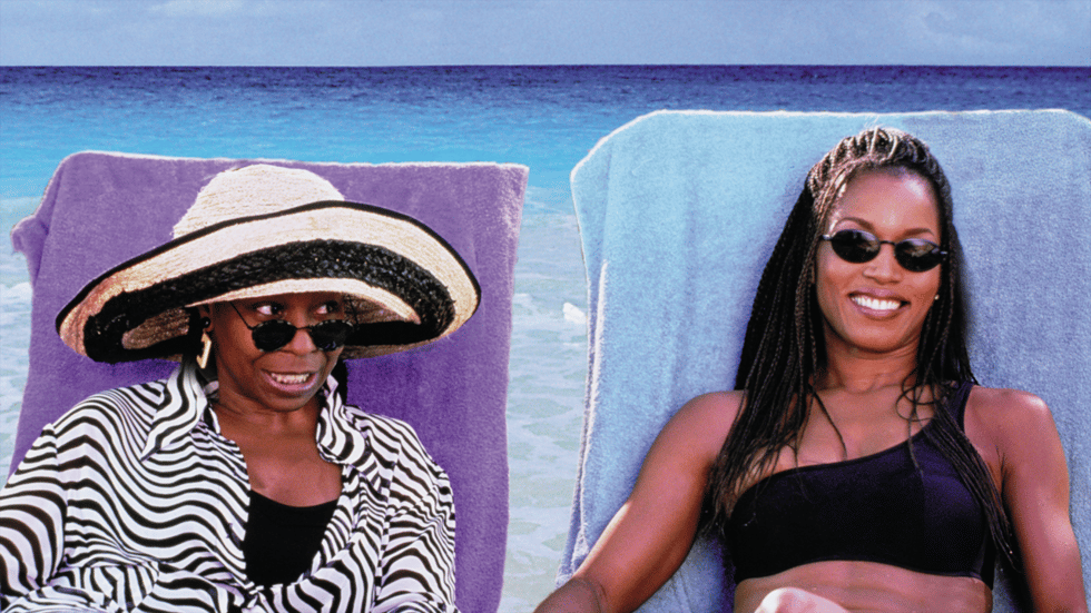 Screenshot of Angela Bassett as Stella in How Stella Got Her Groove Back, smiling in a beach setting under natural sunlight.