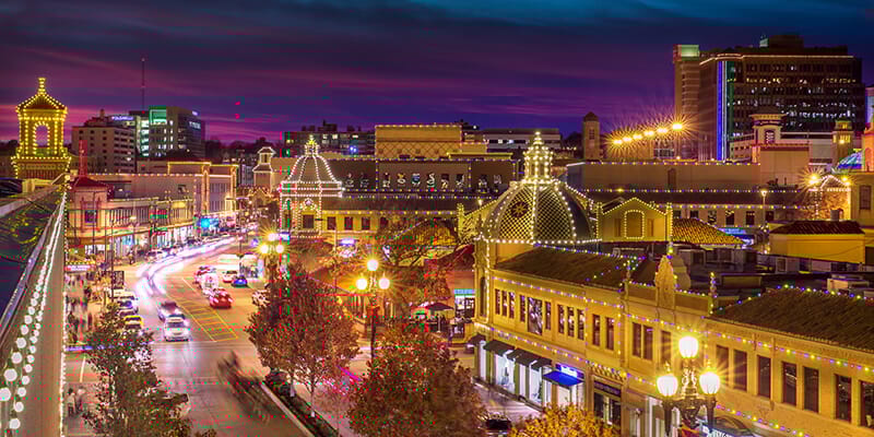 The Kansas City Country Club Plaza lit up at night with festive holiday lights, representing Merchpath’s local roots and community-focused gifting services.