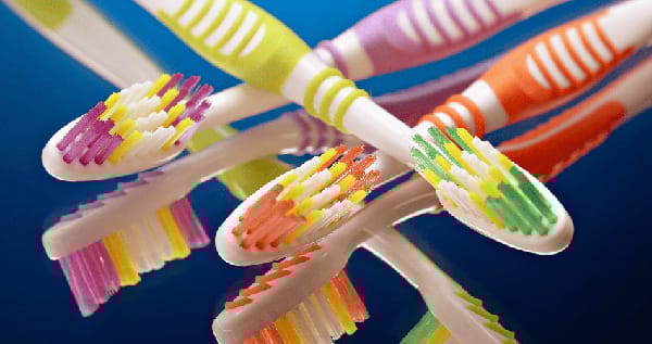 Three toothbrushes overlapping.