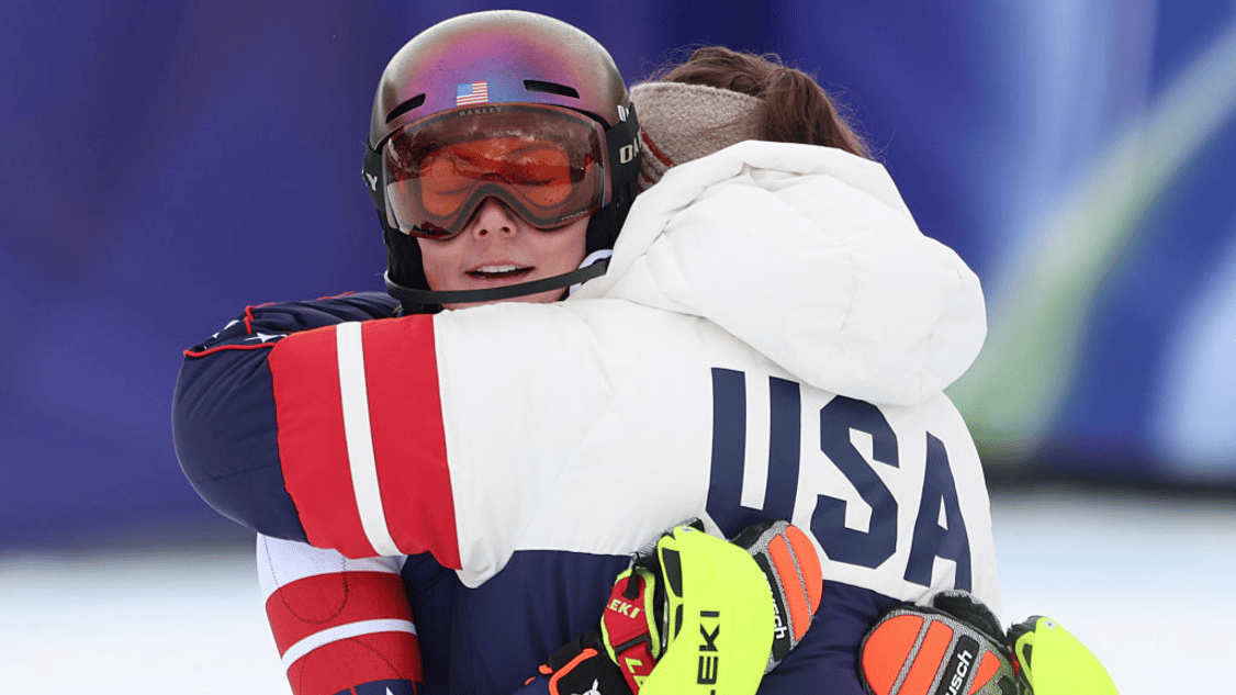 Mikaela Shiffrin of Team United States reacts with her team mate after skiing in the Slalom during the Women's Team Combined on day four of the Milano Cortina 2026 Winter Olympics at Tofane Alpine Skiing Centre on February 10, 2026 in Cortina d'Ampezzo, Italy.