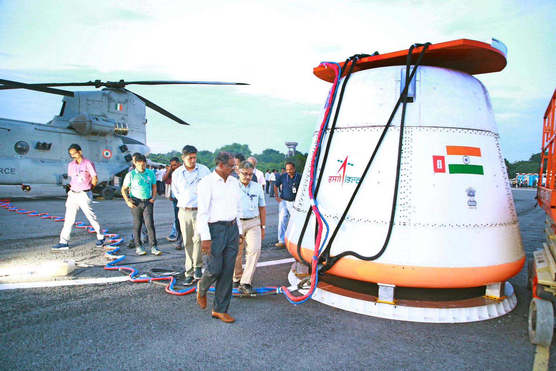 Engineers and recovery personnel inspect the full-scale Gaganyaan crew module ahead of its air drop test at Sriharikota.