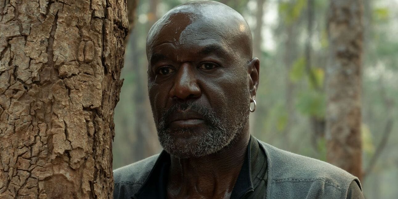 Delroy Lindo as Paul, a Vietnam War veteran, stands in a jungle with a serious expression in a scene from Da 5 Bloods, a Spike Lee film about Black soldiers.