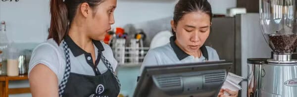 Two cashiers working