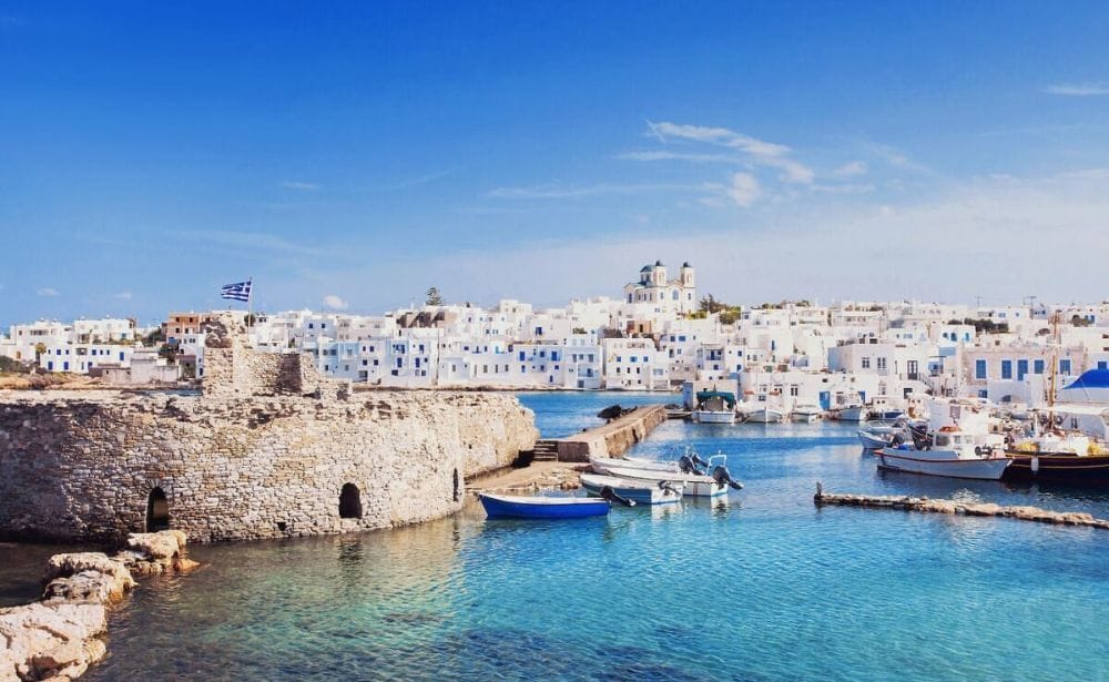 Greek island with white washed buildings and blue roofs